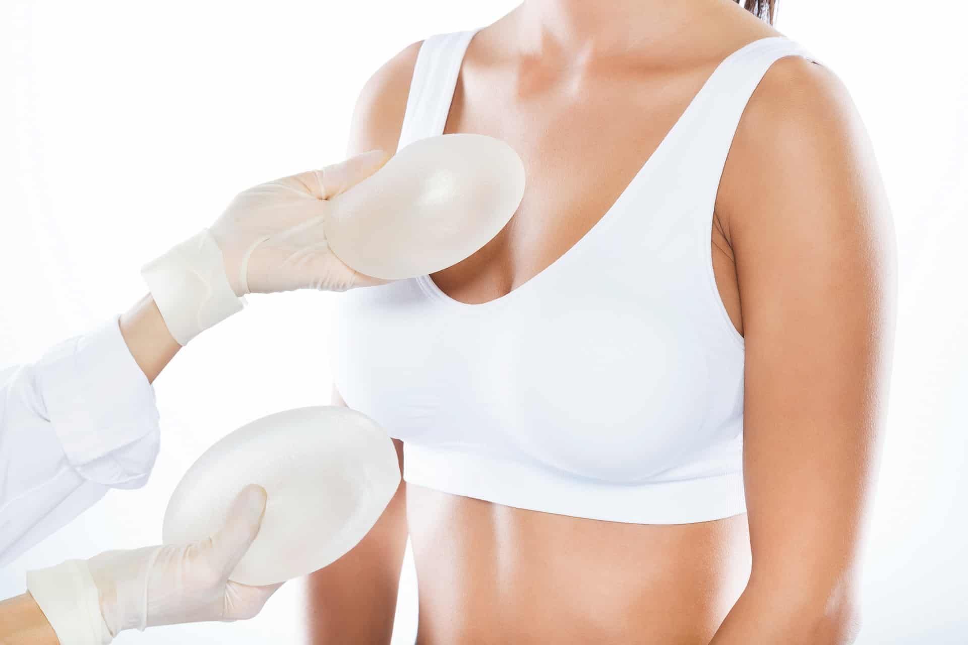 Female doctor choosing mammary prosthesis with her patient over